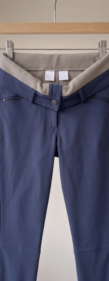 Navy Winterreithose am Bügel, der Bund nach außen umgeschlagen, innen Fleecefutter mit zwei leeren Etiketten – KI-generierte Illustration
