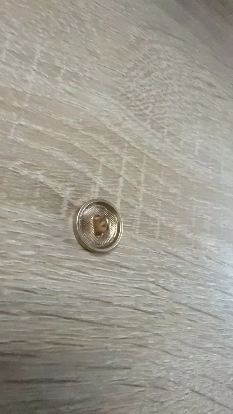 Metallknopf mit eingeprägtem Logo, Nahaufnahme